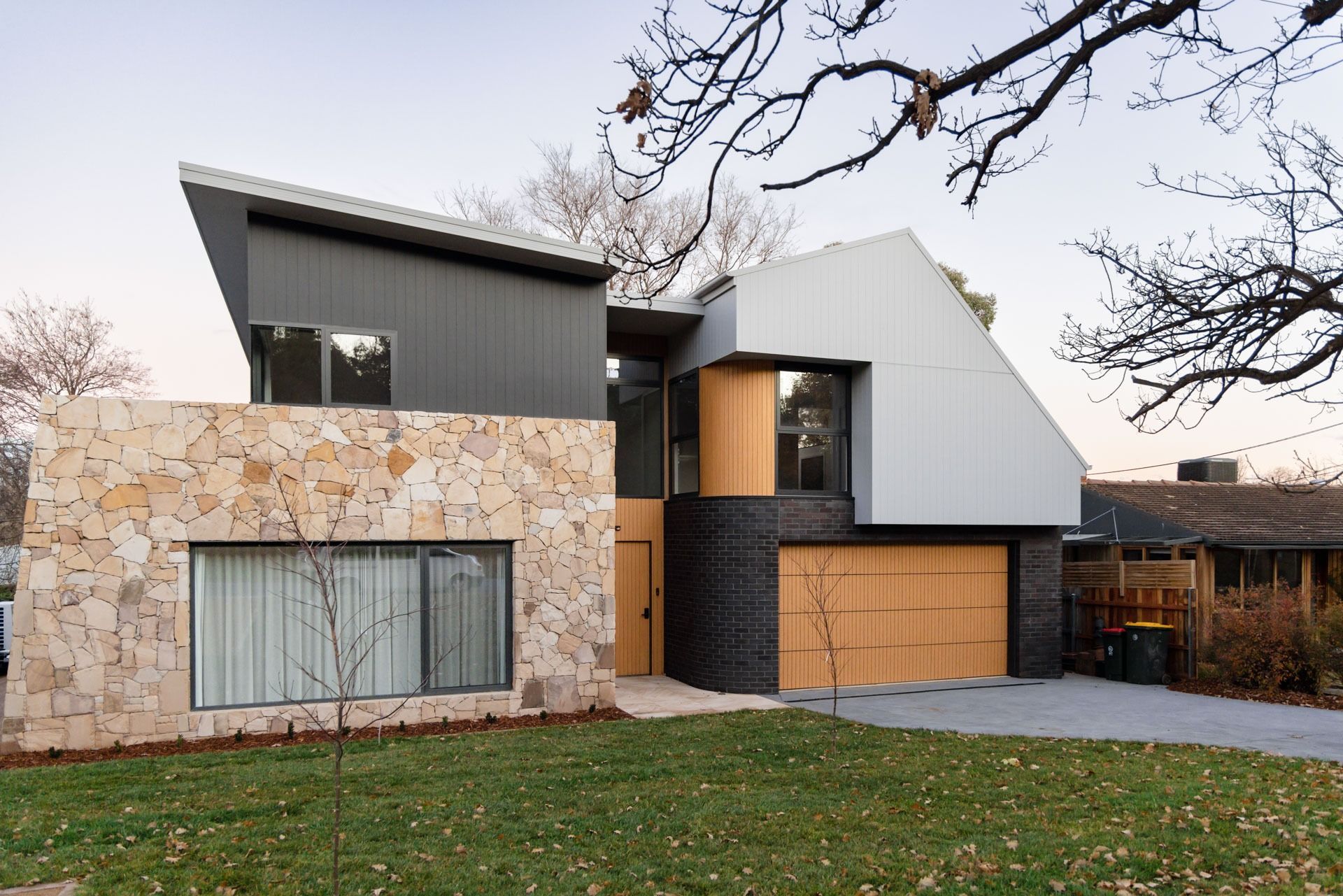 Modern Two-Story House with Stone, Grey, and Wood Exterior — Complete Property Projects In Phillip, ACT
