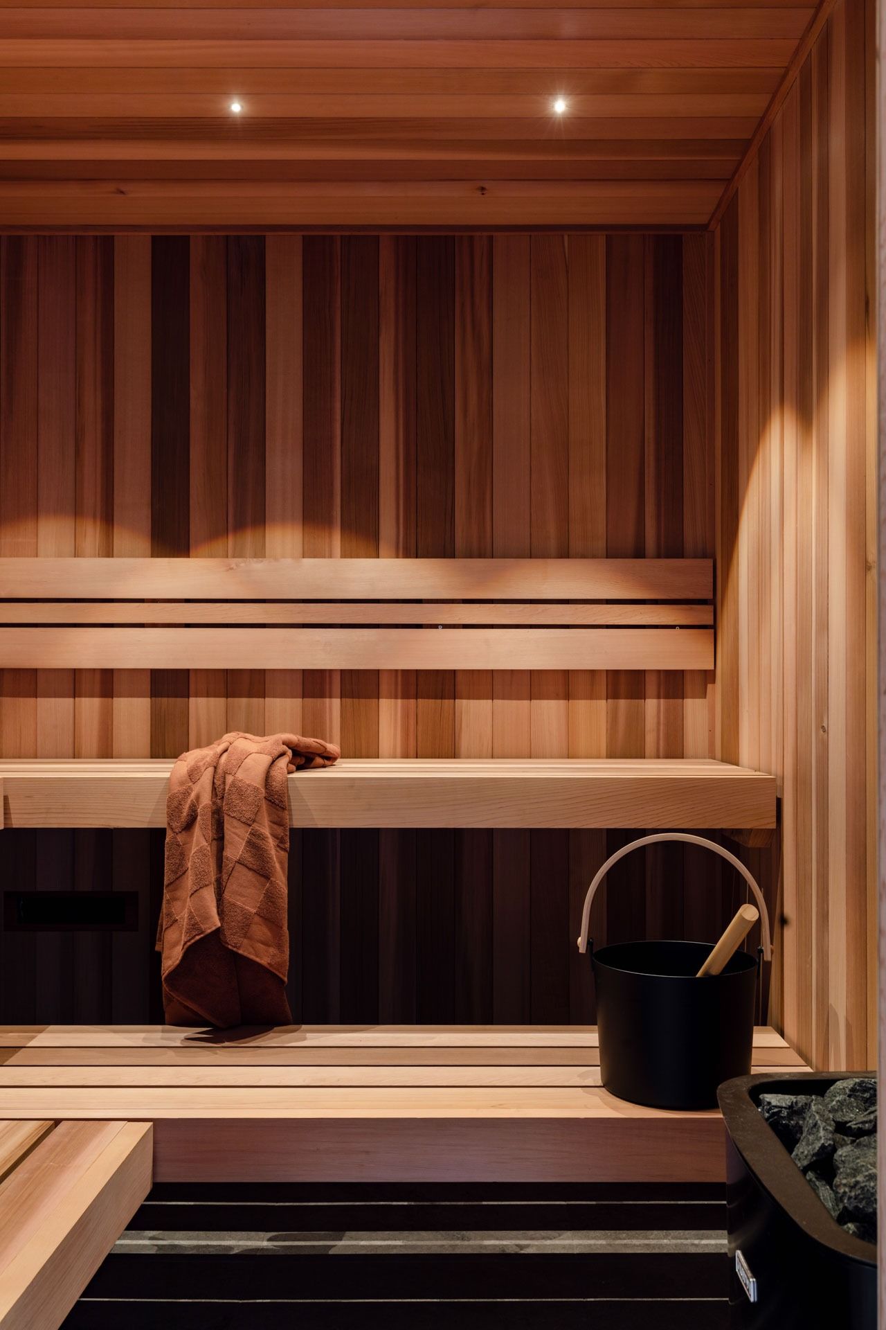 Wood-Paneled Sauna with Wooden Benches, Soft Lighting — Complete Property Projects In Phillip, ACT