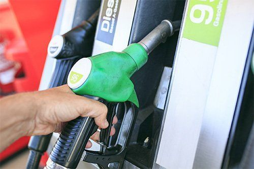 Man Holding Fuel Nozzle — Jacksonville, FL — Paul Murray Oil Inc Man Holding Fuel Nozzle — Jacksonville, FL — Paul Murray Oil Inc