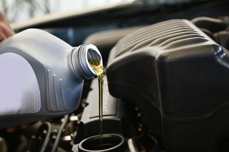 Pouring Oil Into the Car Engine — Jacksonville, FL — Paul Murray Oil Inc Pouring Oil Into the Car Engine — Jacksonville, FL — Paul Murray Oil Inc