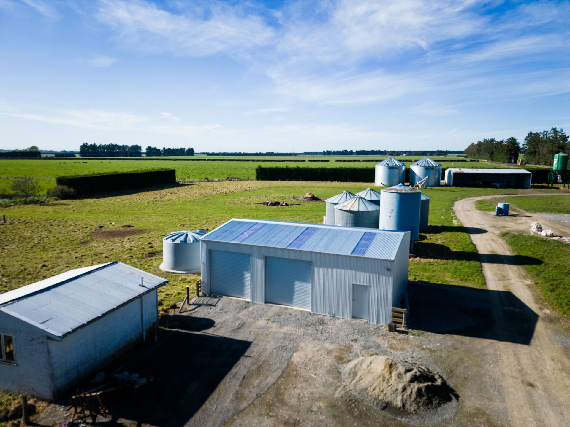 An aerial view of a farm with a lot of buildings and silos.