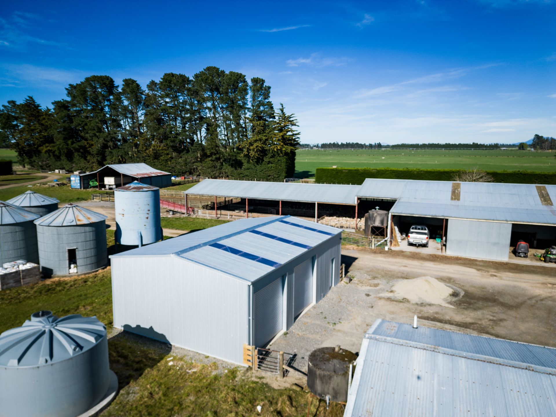 An aerial view of a farm with a lot of buildings and silos.