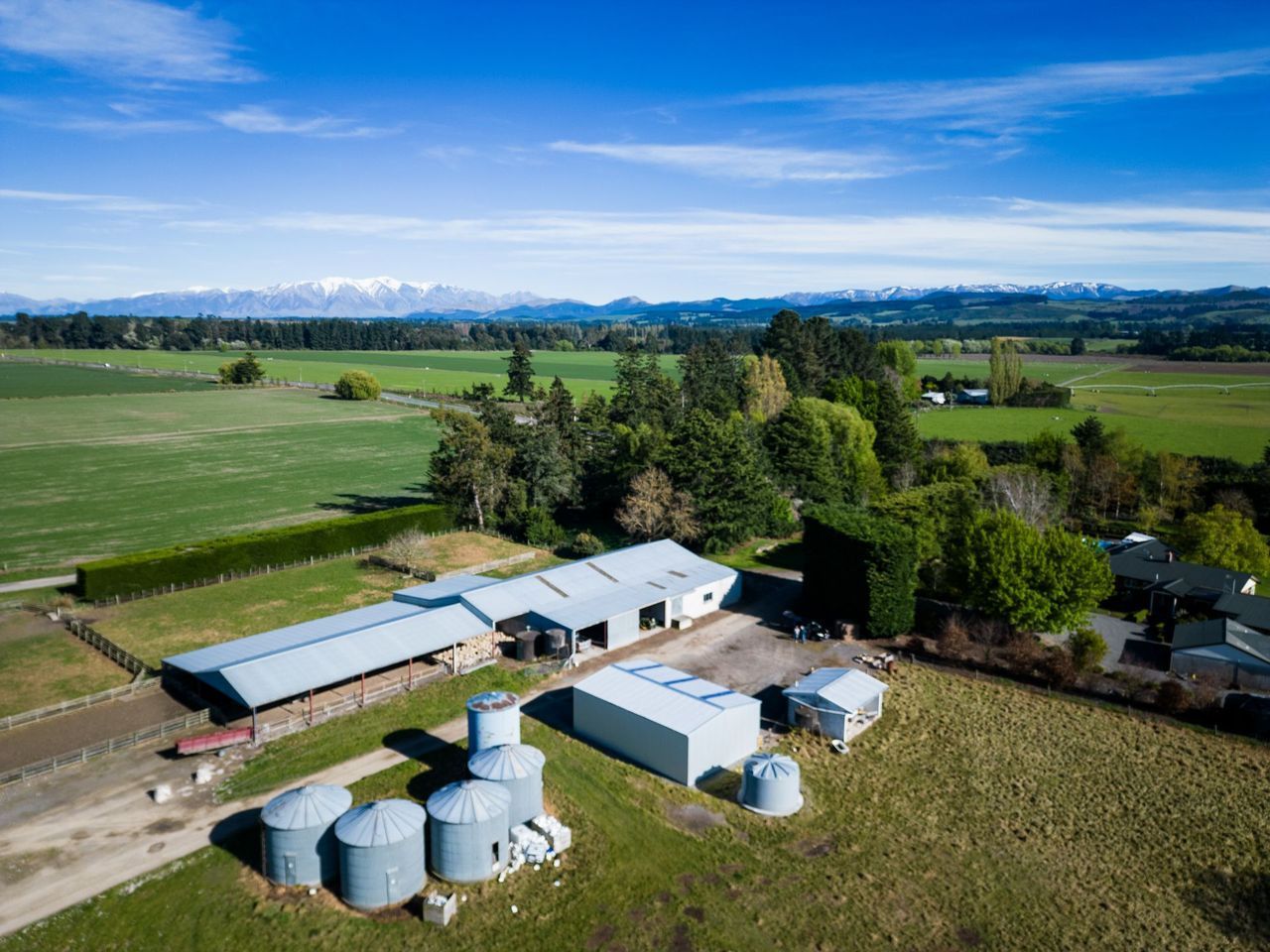 An aerial view of a farm with a lot of silos and buildings.