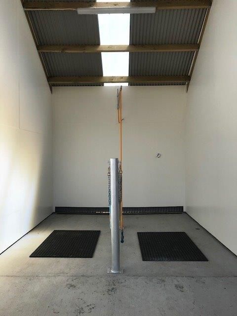 An empty room with two black mats on the floor