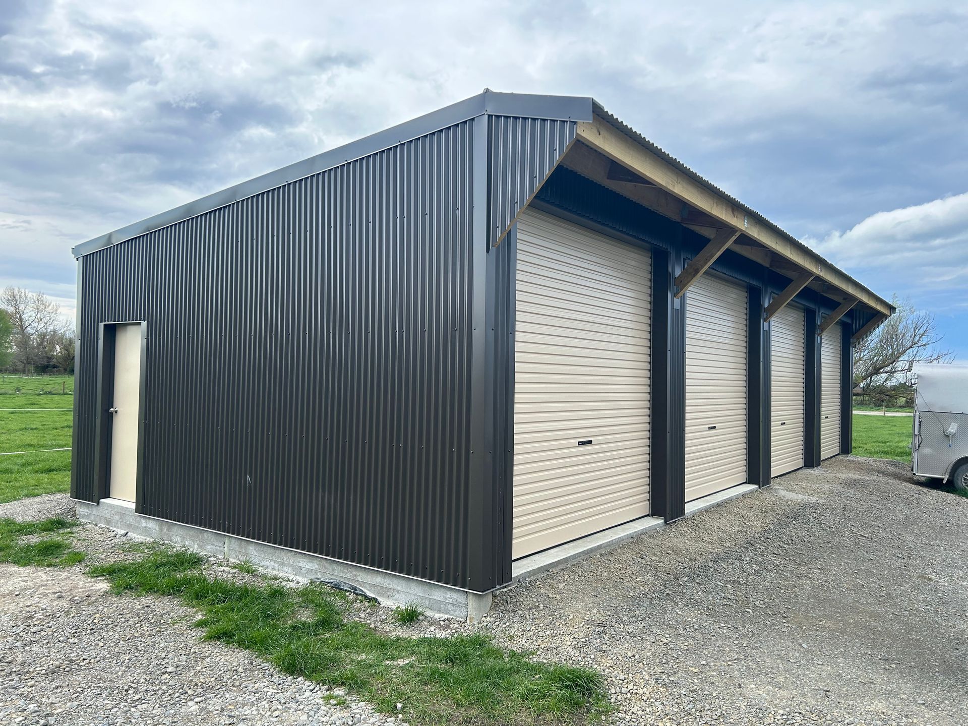 A large metal building with a trailer parked in front of it.