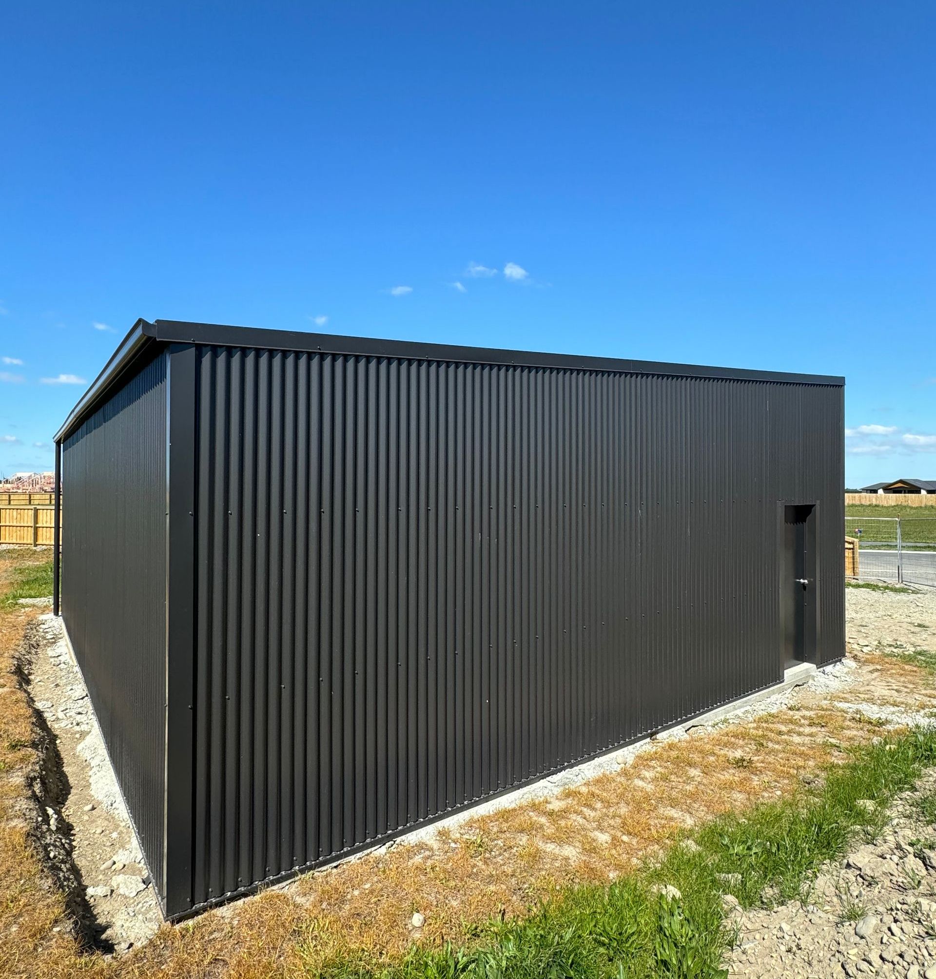 A black building with a blue sky in the background