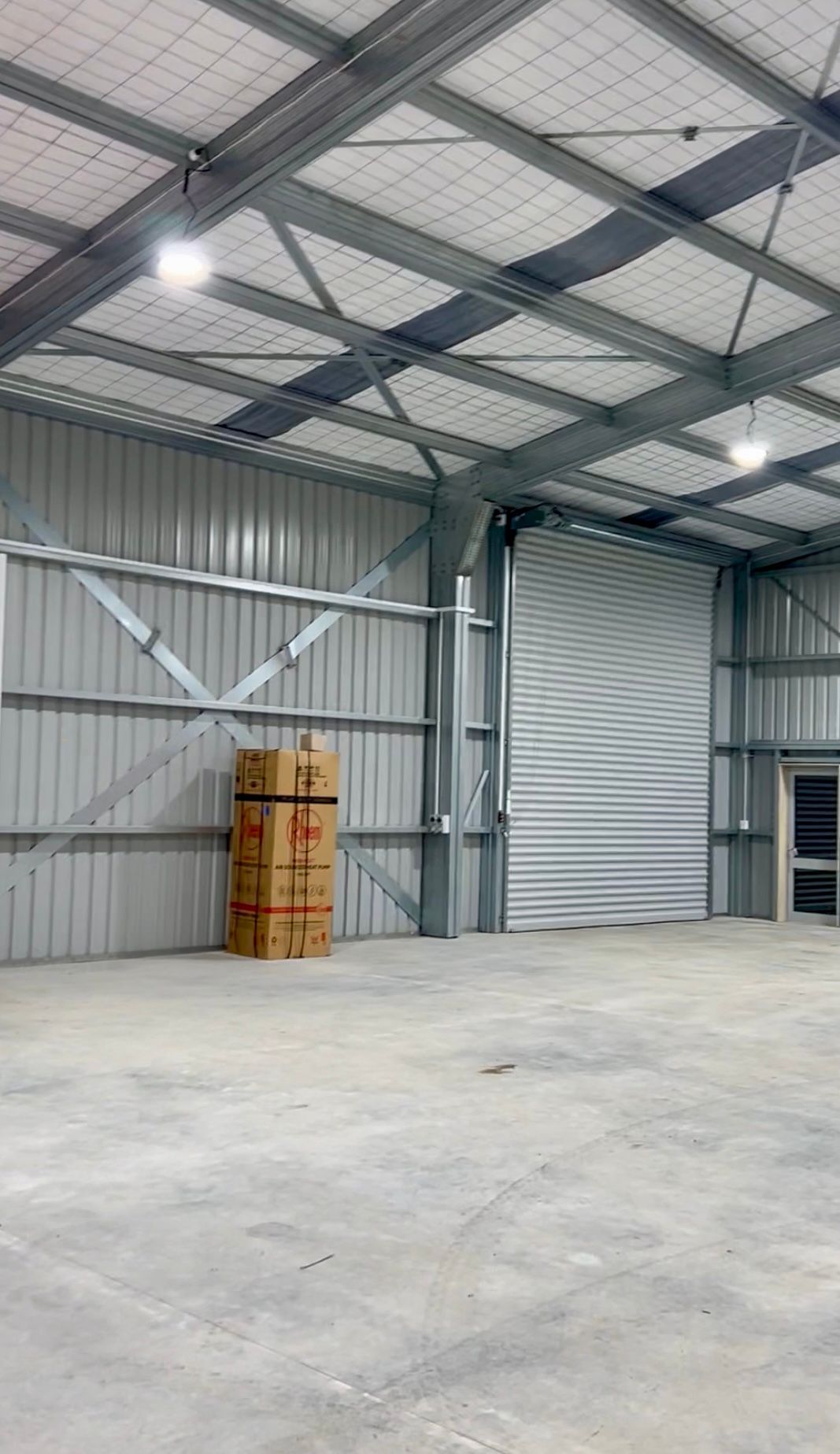 A large empty warehouse with boxes stacked on top of each other.