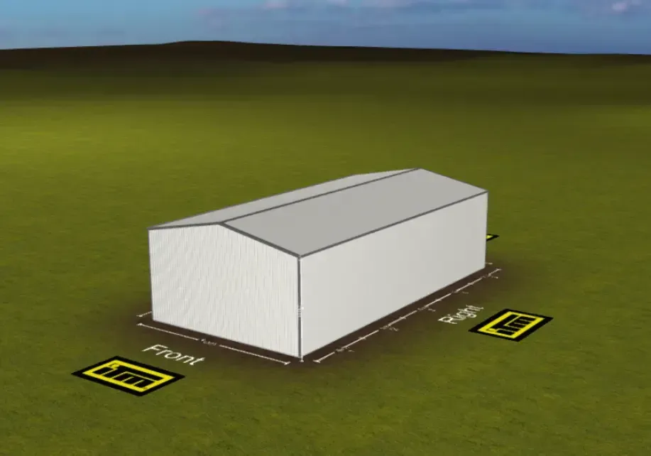 A white rectangular warehouse on a green field with two yellow measurement signs.