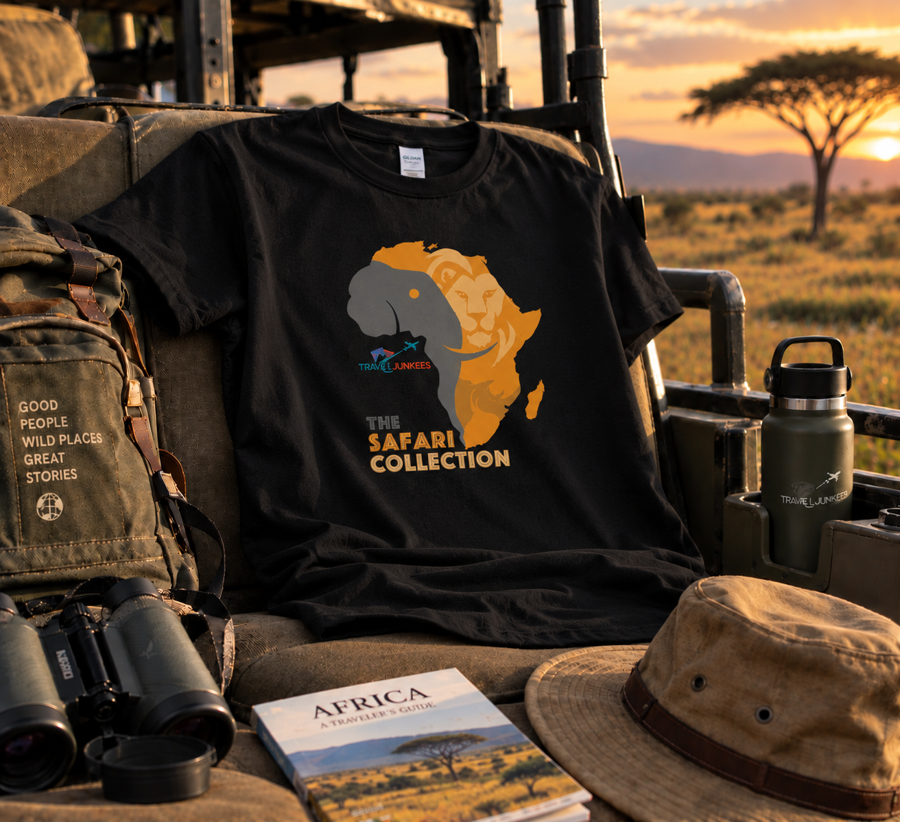 Black T-shirt with Africa graphic displayed among safari gear at sunset.