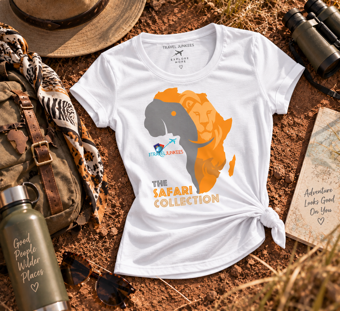 Black safari-themed T-shirt with orange lion graphic on a rustic outdoor flat lay