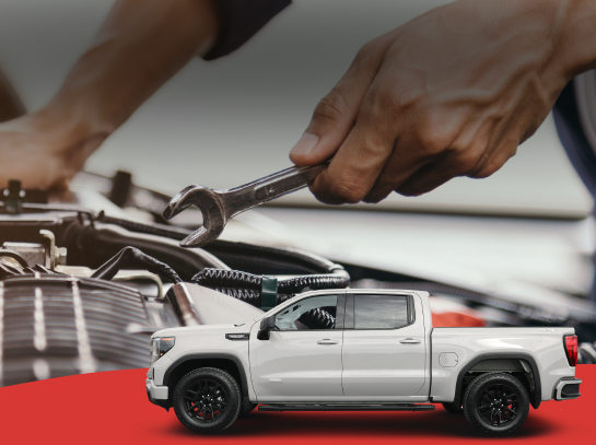 Hands repairing a guitar with a white pickup truck in the foreground