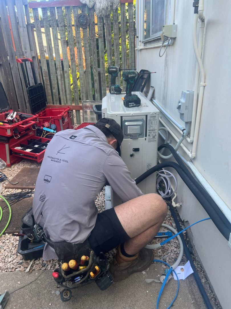 A Man Is Working On A Residential Site Organising Cable — Kilowatts & Cool Whitsundays In Strathdickie, QLD