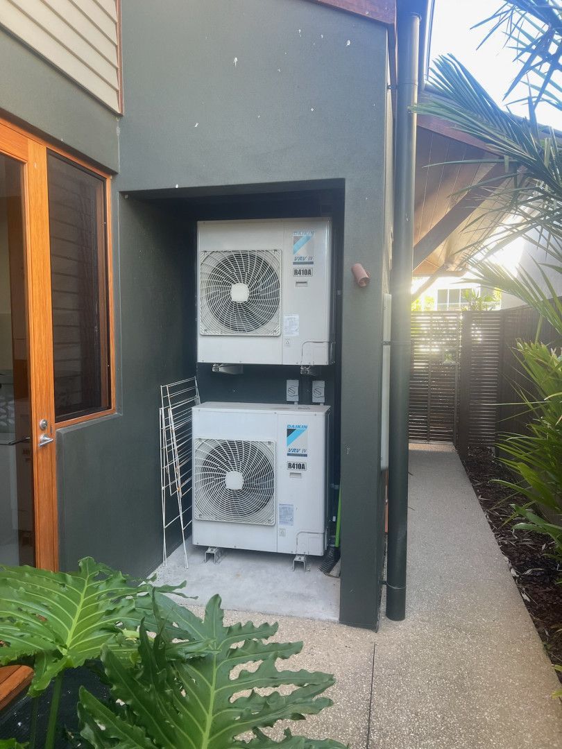 Two Air Conditioning Units Sitting On Top Of Each Other Outside A House — Kilowatts & Cool Whitsundays In Strathdickie, QLD