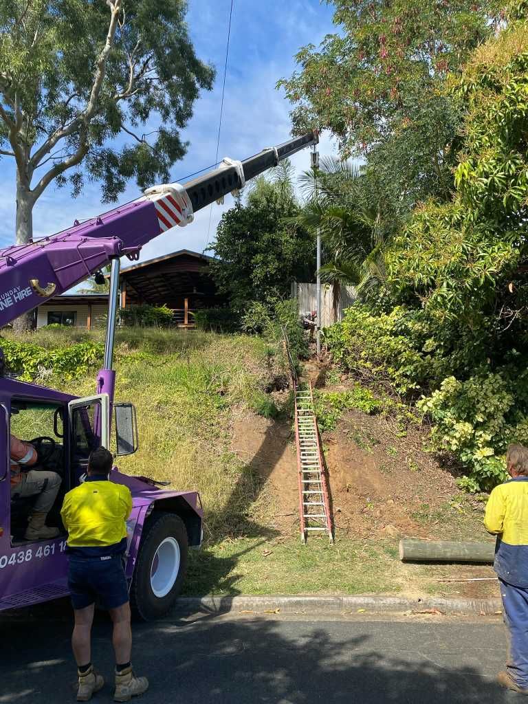 A Truck With a Crane Attached to It is Parked on the Side of the Road — Kilowatts & Cool Whitsundays In Strathdickie, QLD