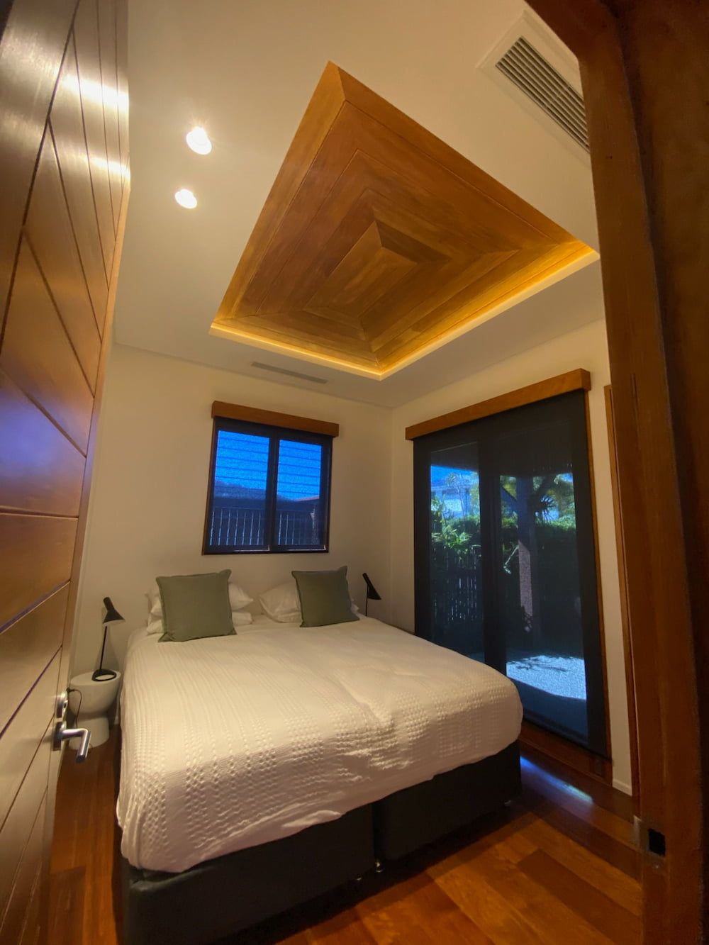 A Bedroom With a Large Bed and a Wooden Ceiling — Kilowatts & Cool Whitsundays In Airlie Beach, QLD