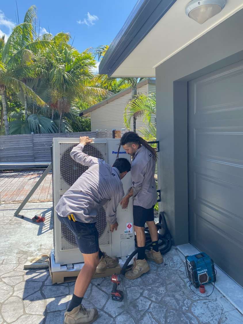 Two Men Are Working on an Air Conditioner — Kilowatts & Cool Whitsundays In Strathdickie, QLD