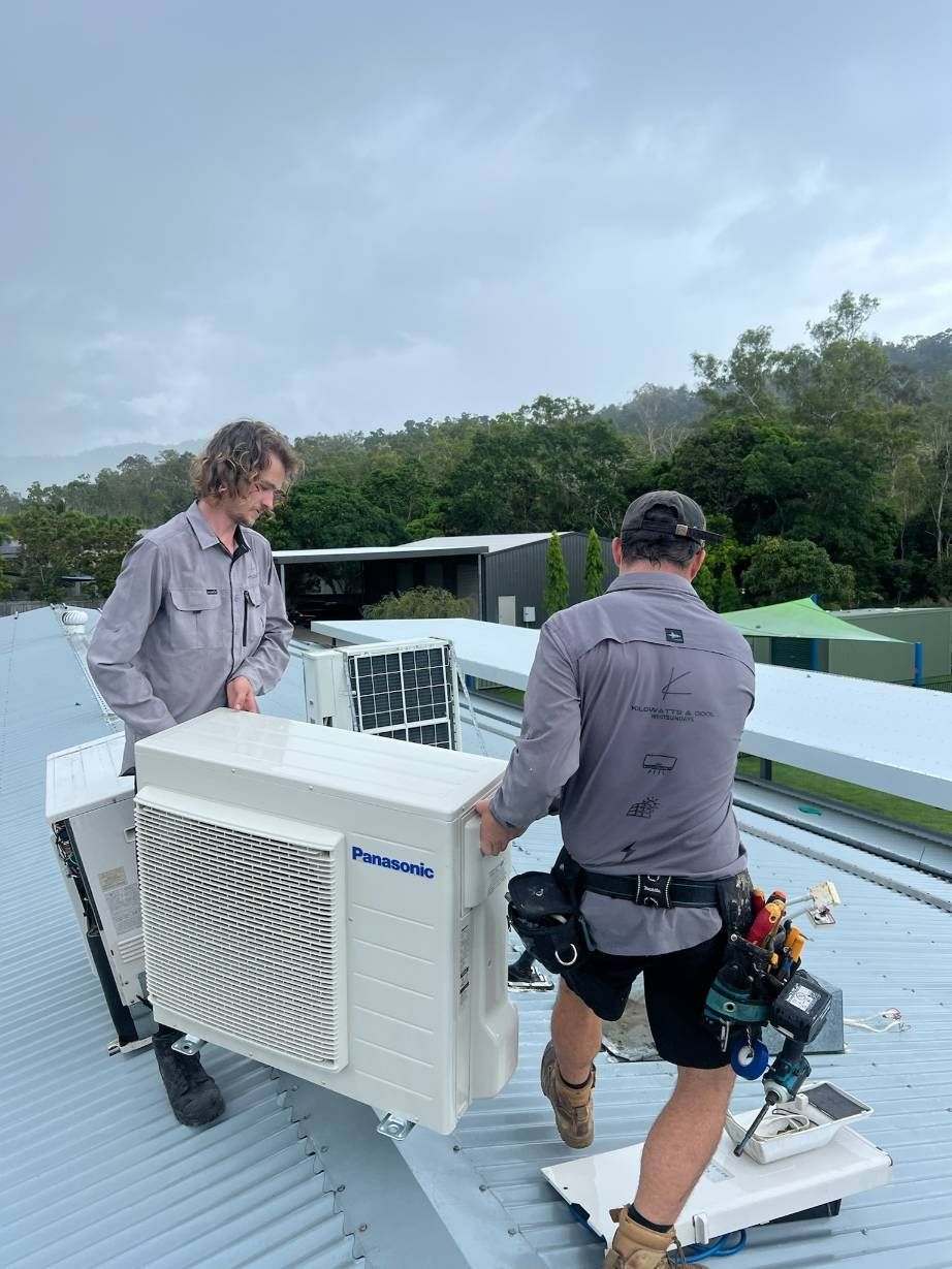 Two Men Are Working on an Air Conditioner on the Roof — Kilowatts & Cool Whitsundays In Strathdickie, QLD