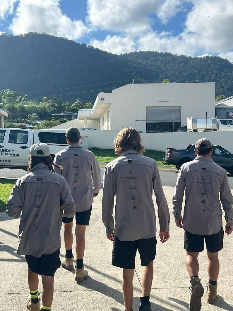 A Group of Men Are Walking Down a Street — Kilowatts & Cool Whitsundays In Strathdickie, QLD