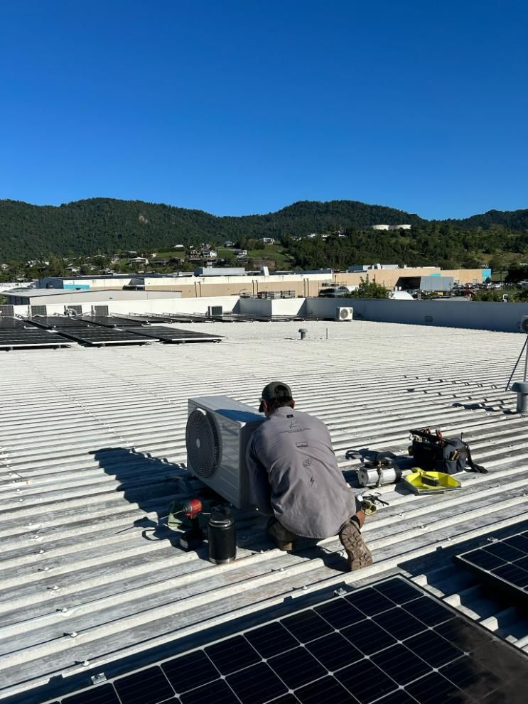 A Panasonic Air Conditioner Is Sitting on Top of A Metal Roof — Kilowatts & Cool Whitsundays In Cannonvale, QLD