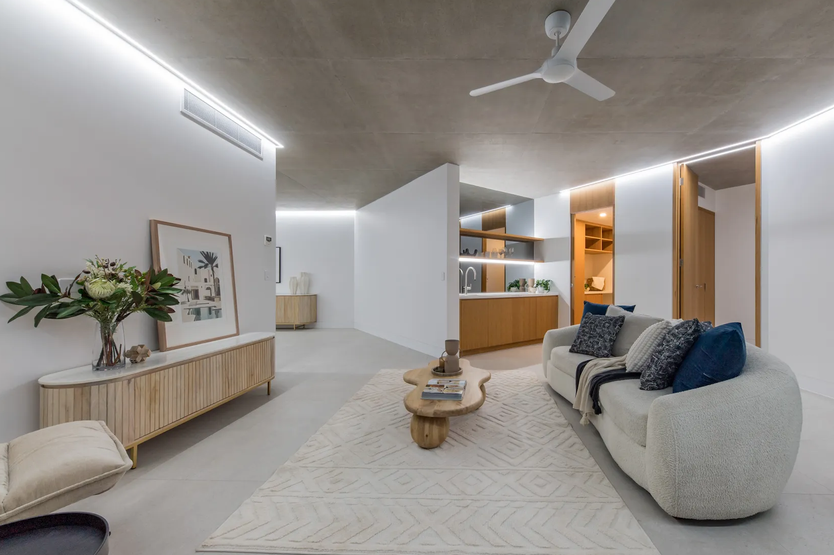 An Air Conditioning Unit Set Up On A Wall In Front Of A Fan — Kilowatts & Cool Whitsundays In Strathdickie, QLD