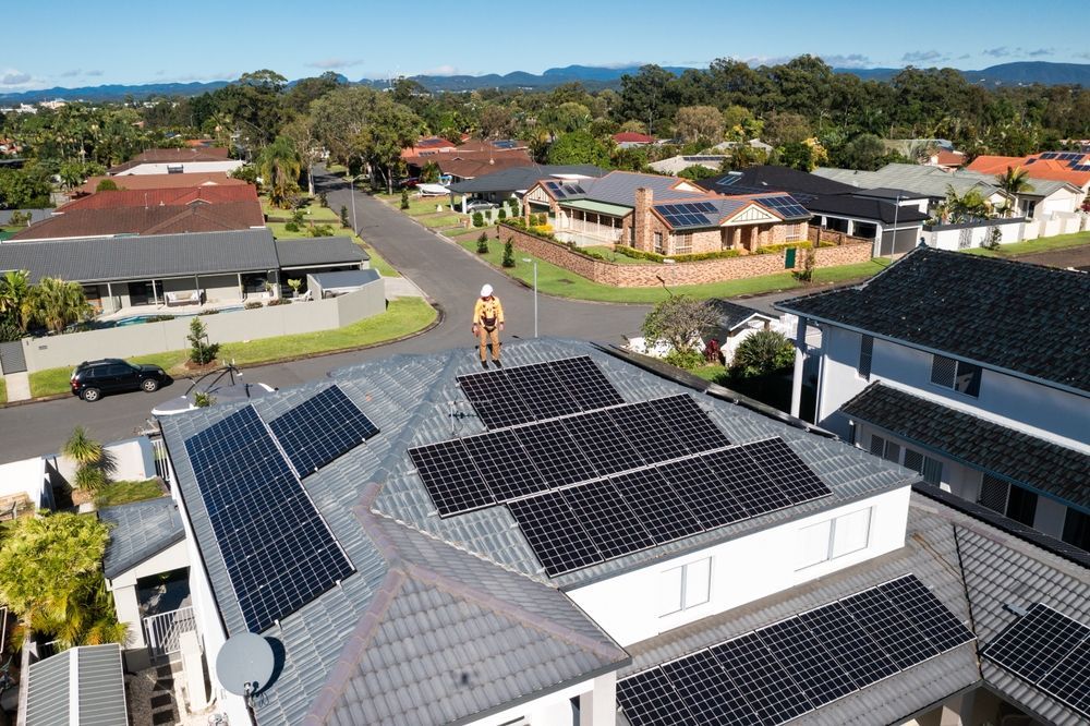 A Solar Panel Is Sitting On Top Of A Lush Green Field Next To Tents — Kilowatts & Cool Whitsundays In Strathdickie, QLD