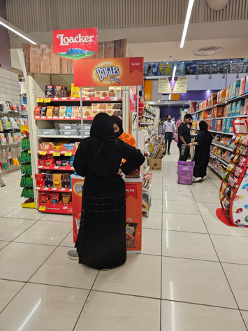 A woman standing in front of a loacker sign