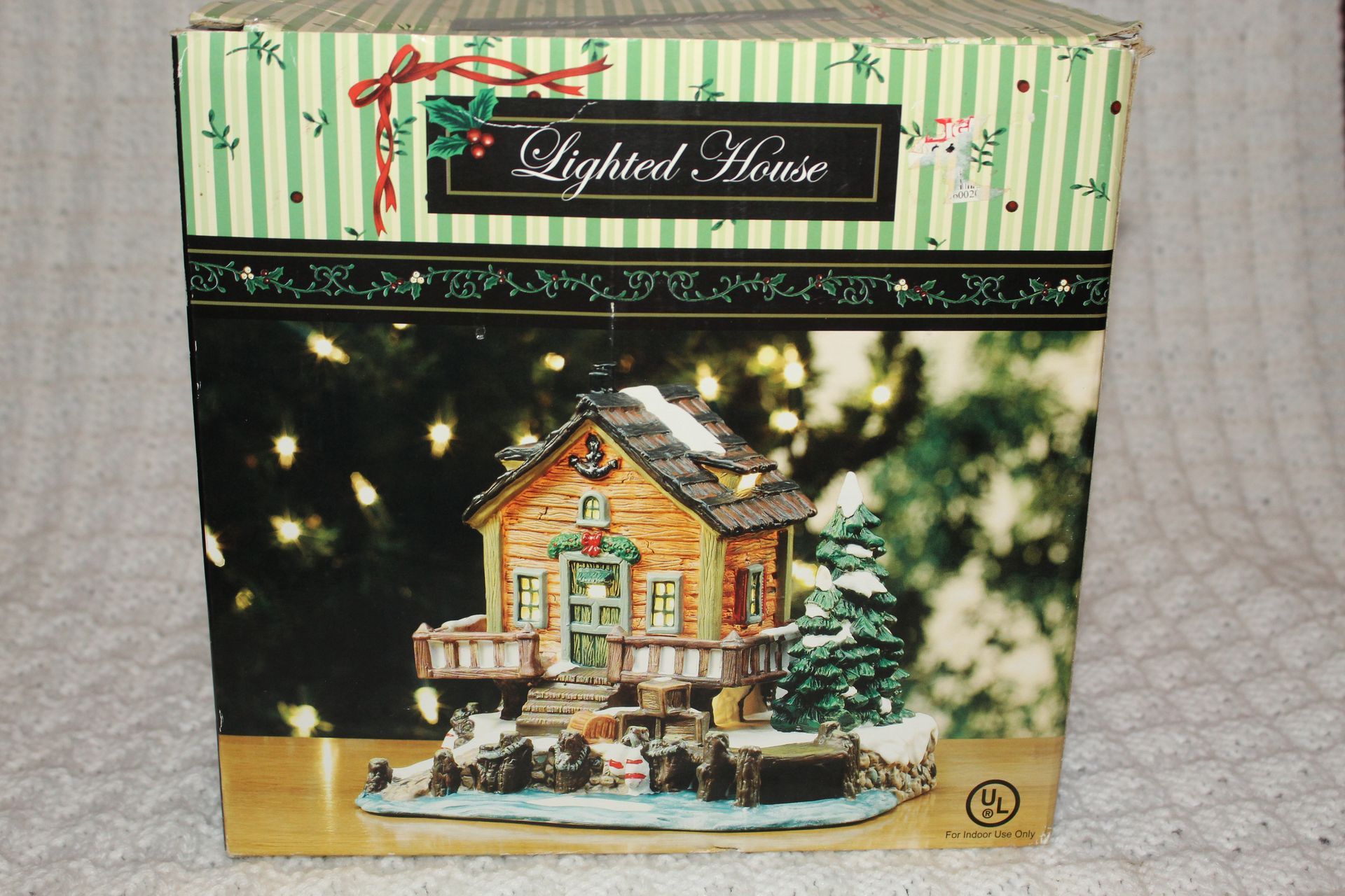 Hallmark ornament box showing a lit miniature house against a festive background