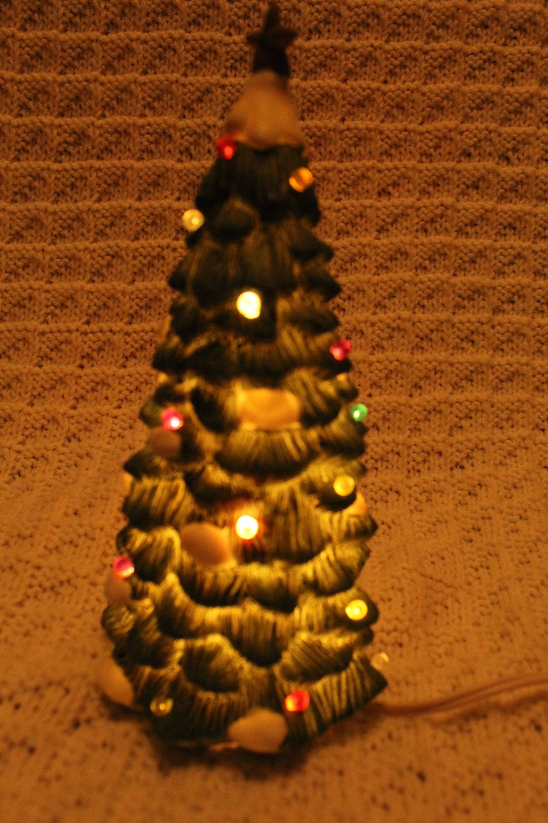 Blue holiday box with a decorated Christmas tree topped by a star and snowy ornaments