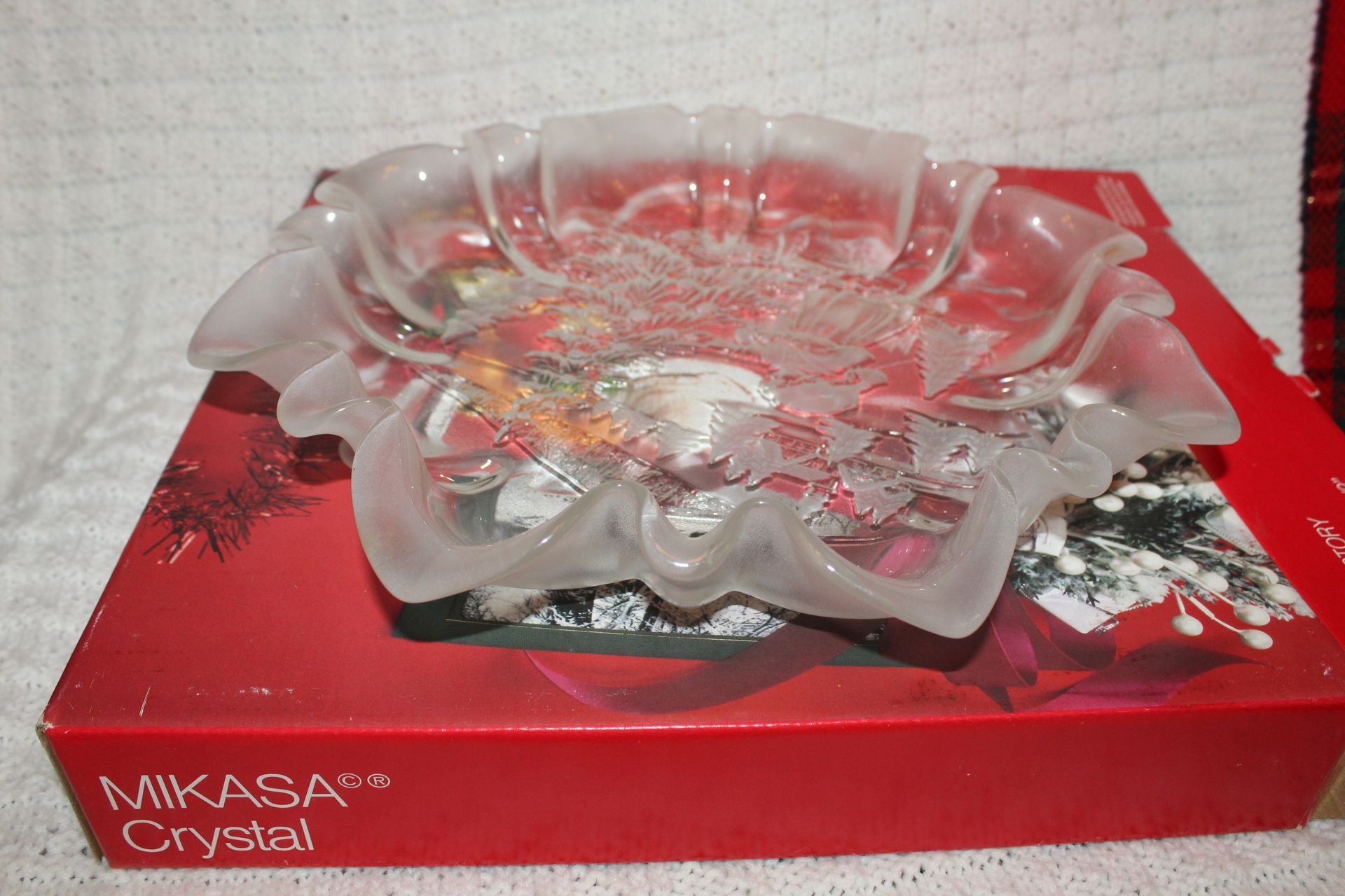 Clear etched glass flower-shaped dish on a wooden table