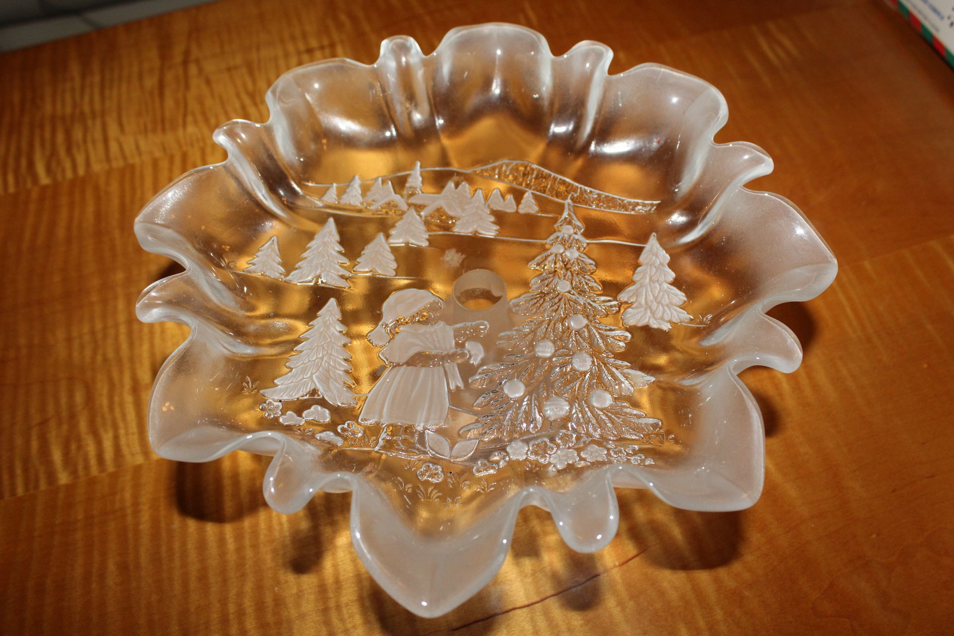 Clear glass bowl with a frosted Christmas tree design on a wooden table