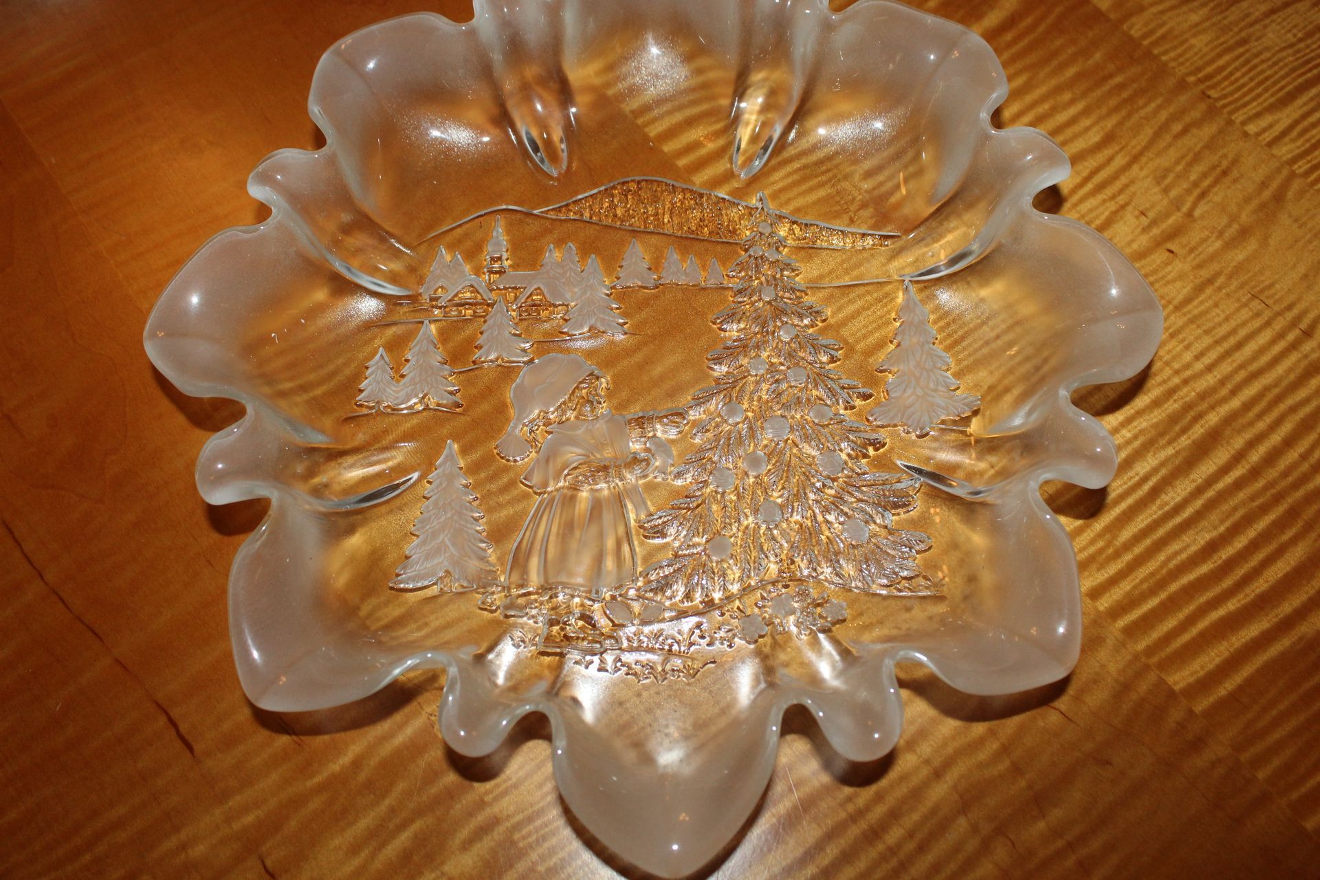 Clear etched glass flower-shaped dish on a wooden table