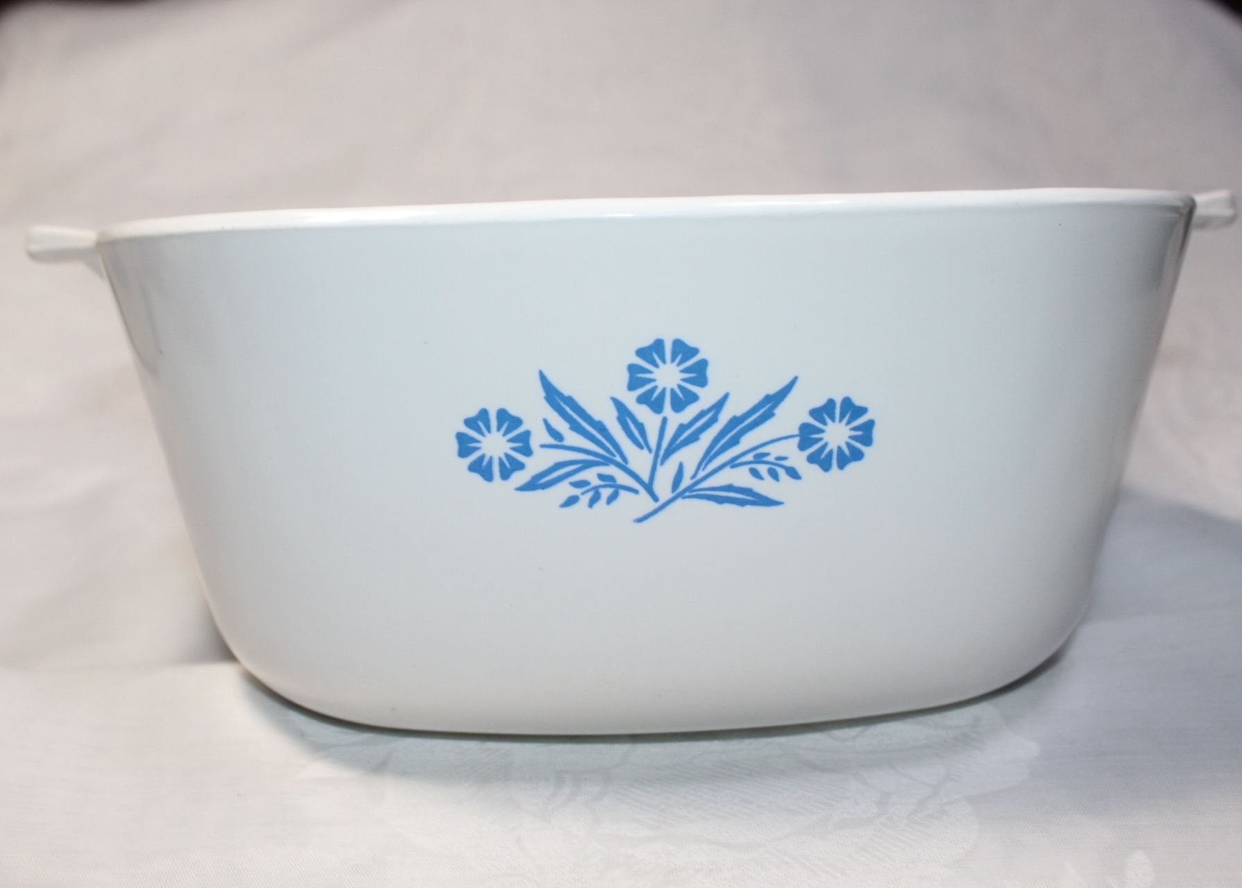White ceramic bowl with blue floral pattern on the side