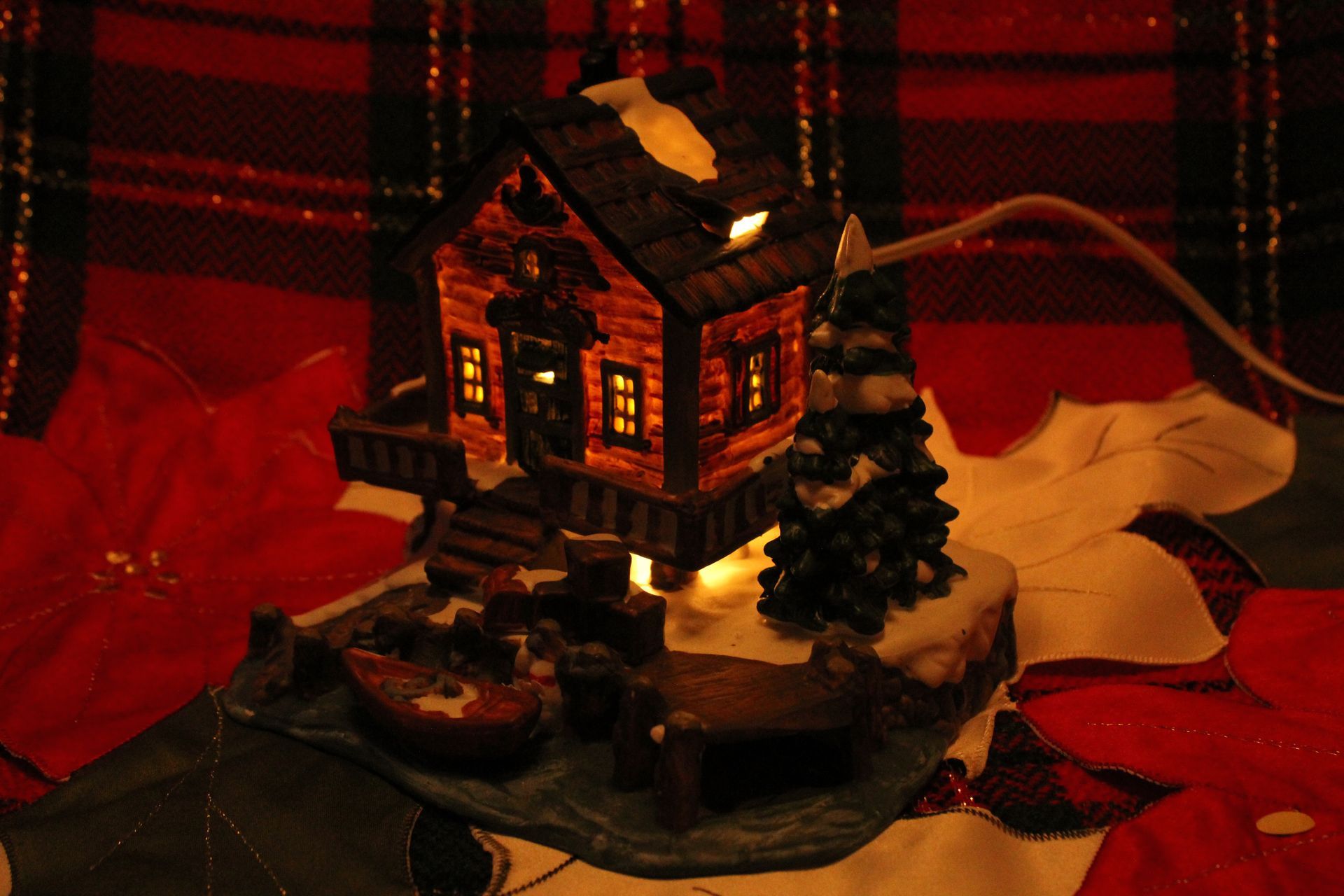 Hallmark ornament box showing a lit miniature house against a festive background