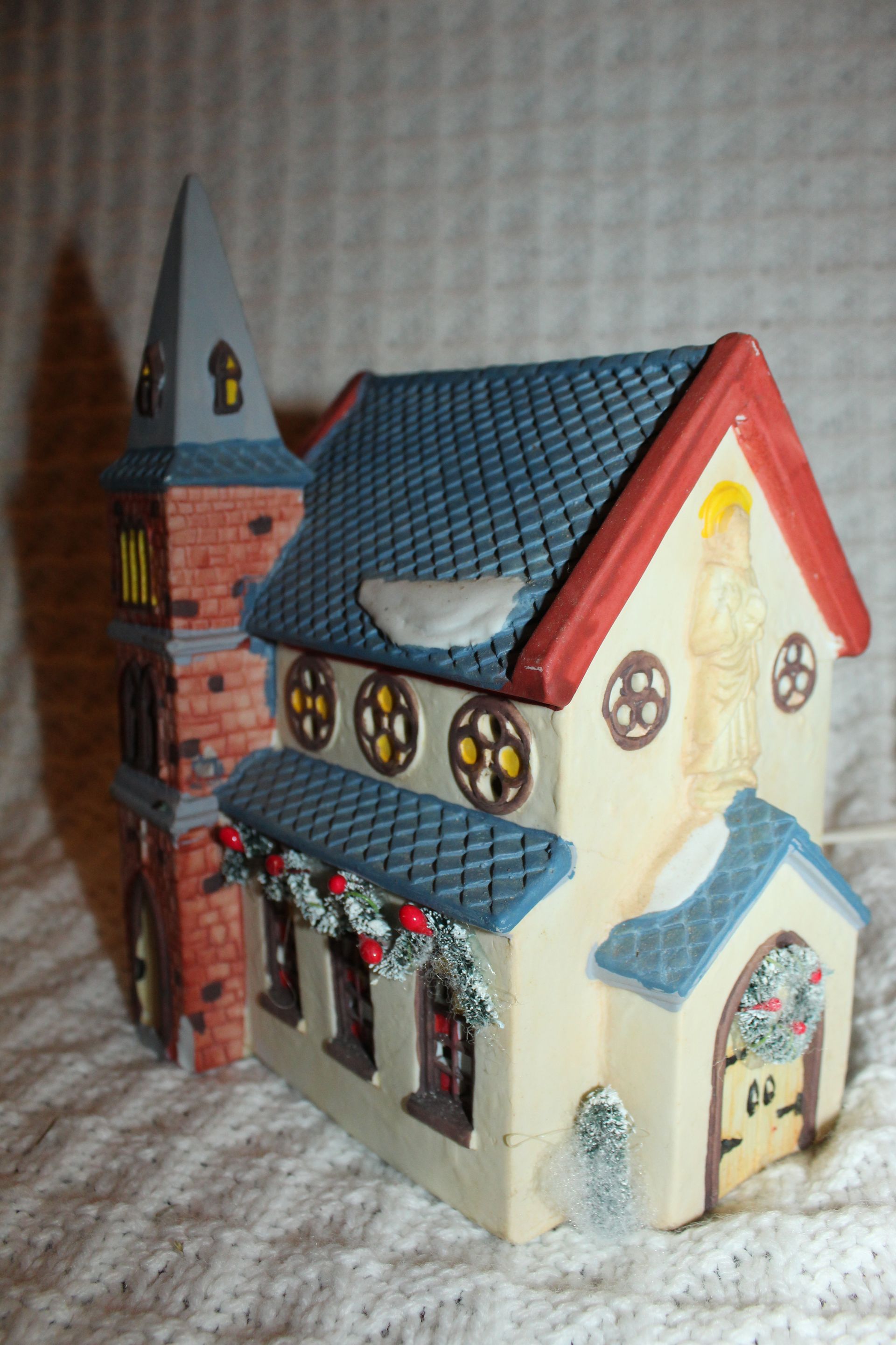 Dickensville collectible church box with a red banner, showing a miniature church illustration on the front.