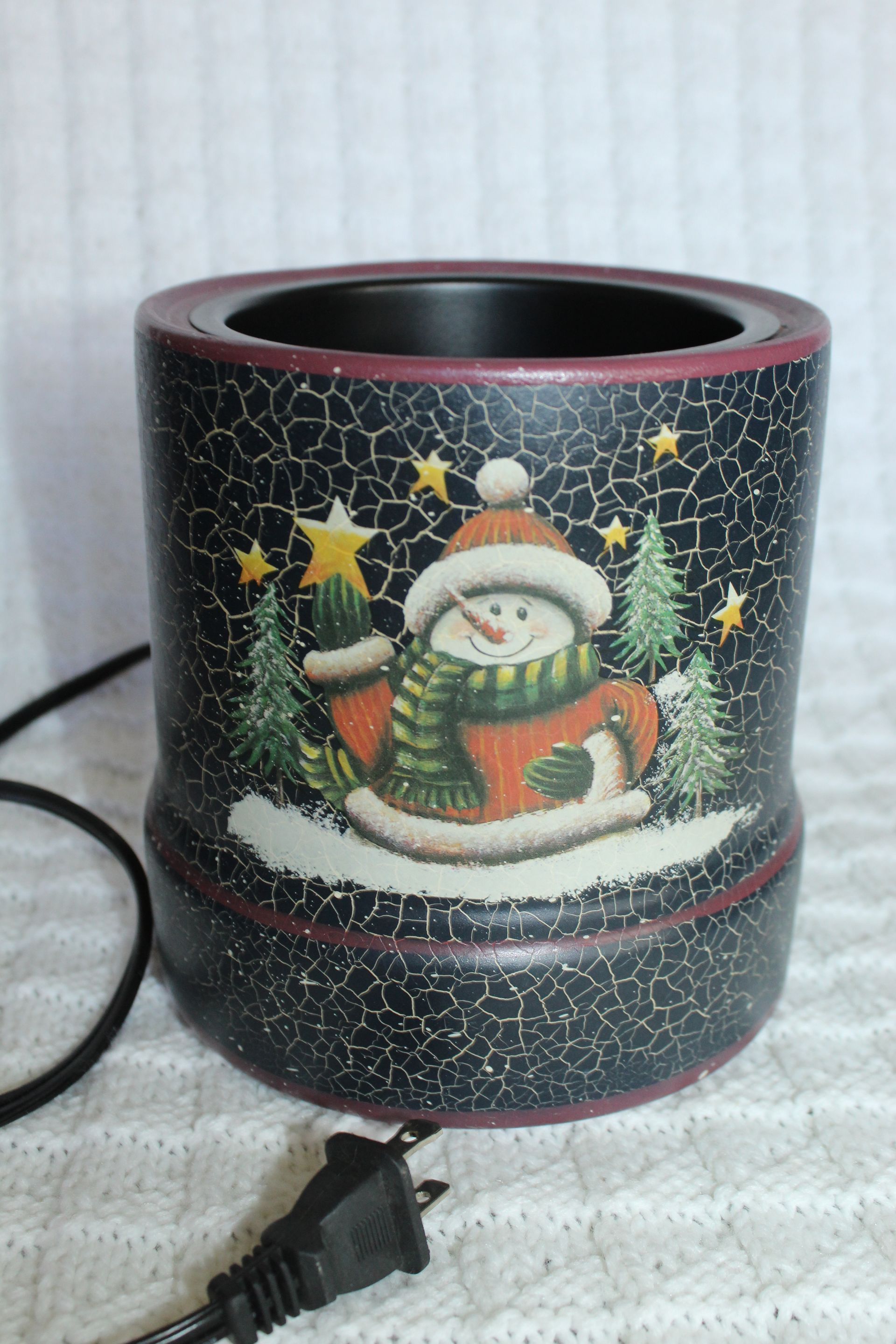 Snowman holiday ceramic mug warmer with Christmas lights and a black power cord