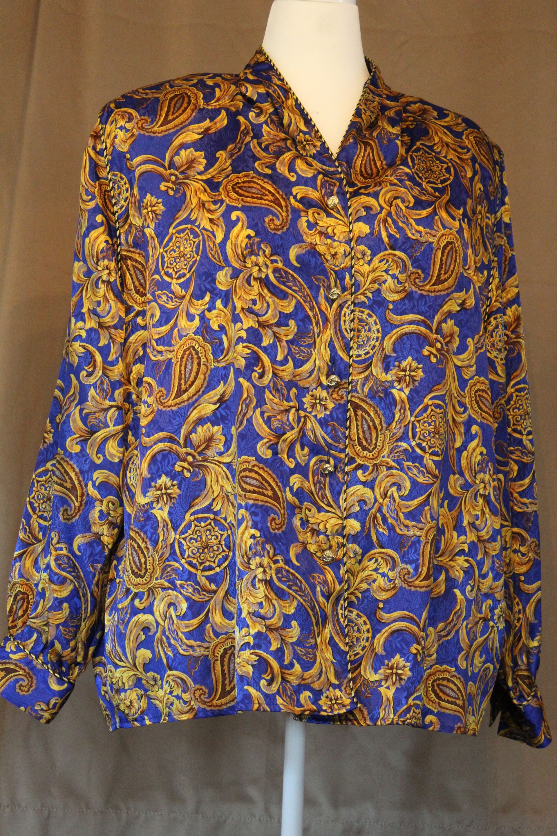 Blue and gold patterned long-sleeve button-up shirt on a mannequin