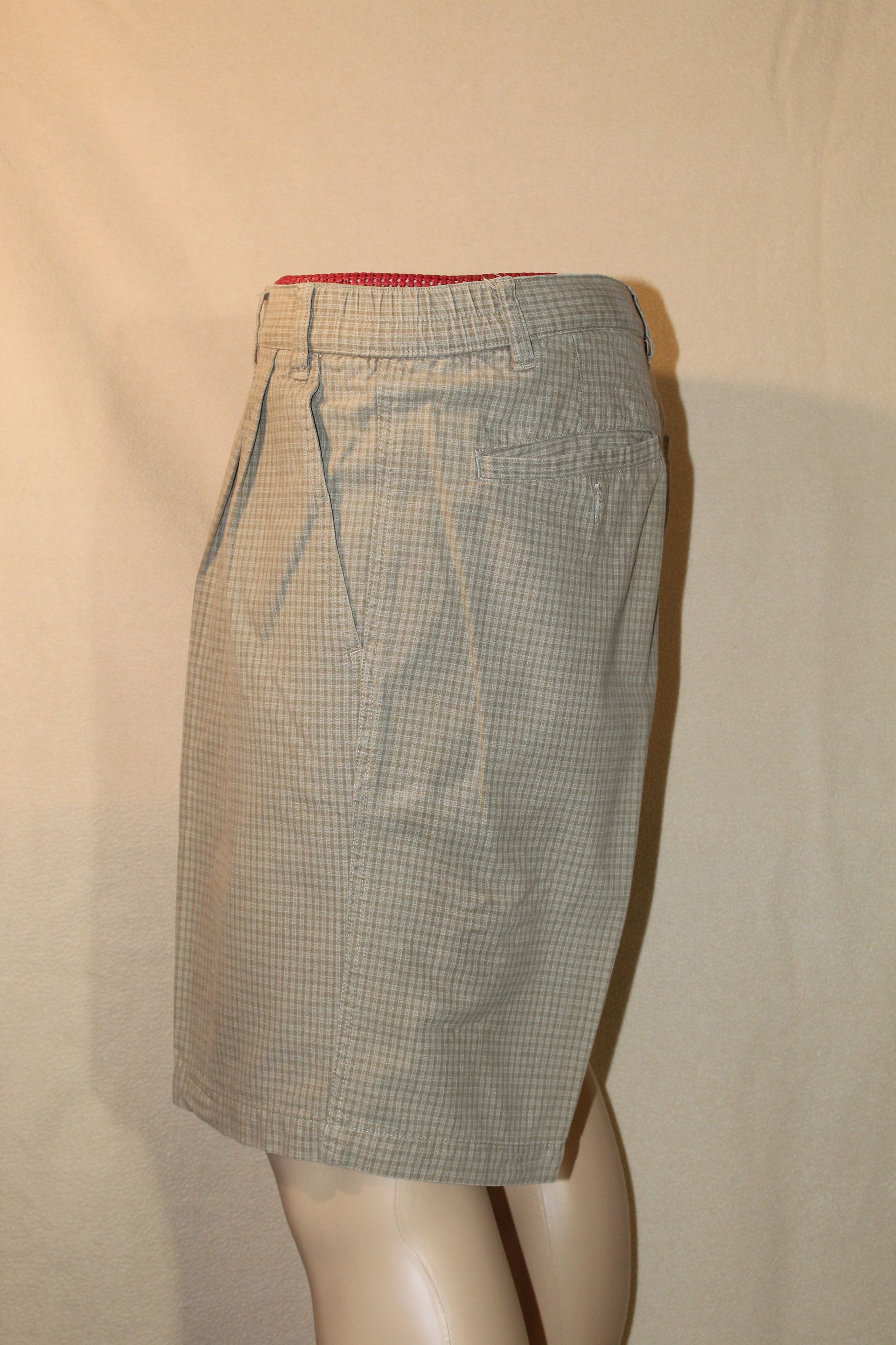 Light blue patterned shorts with a red waistband on a mannequin's lower body