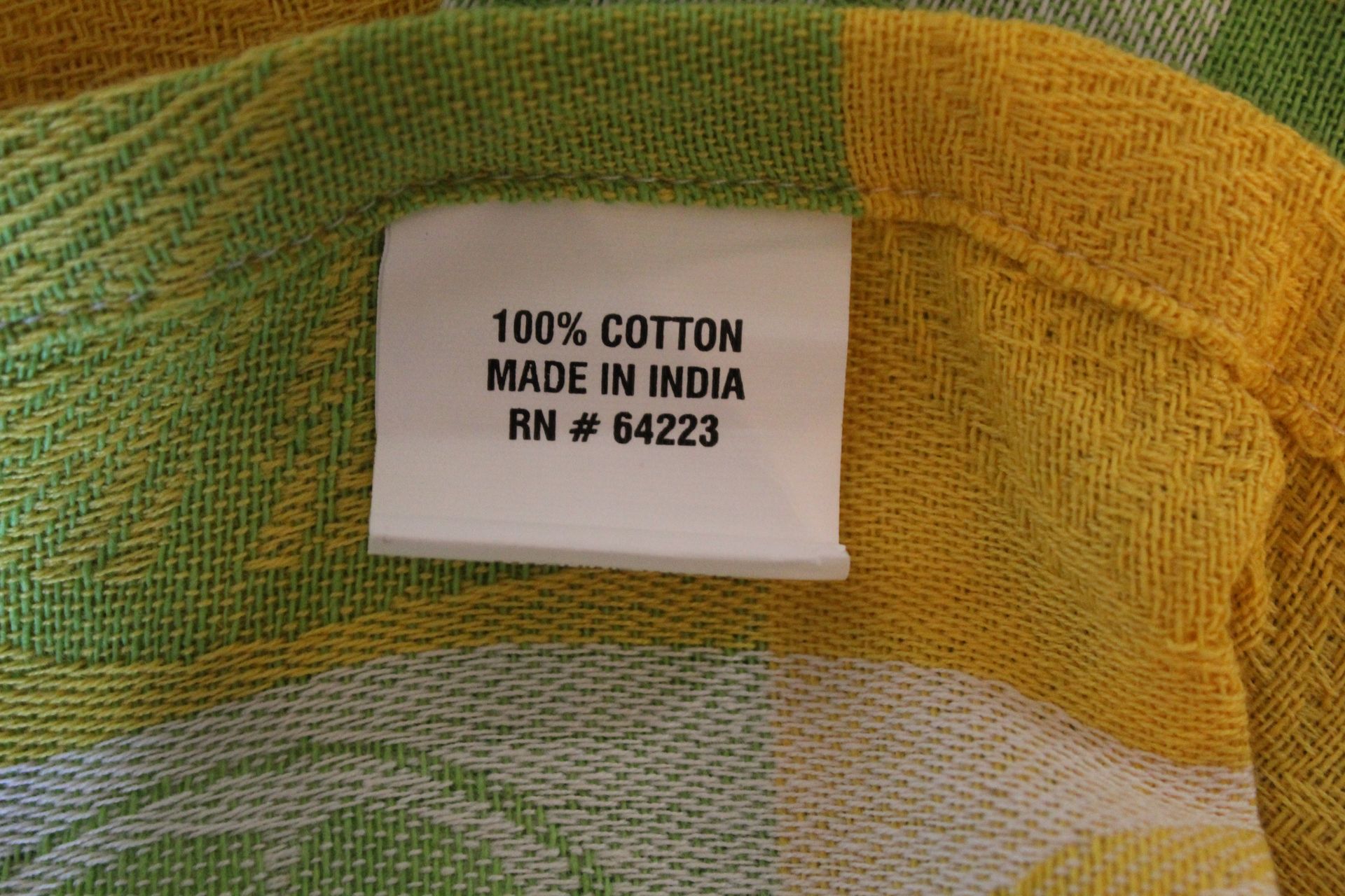 Yellow, green, and white checkered fabric with citrus slice patterns