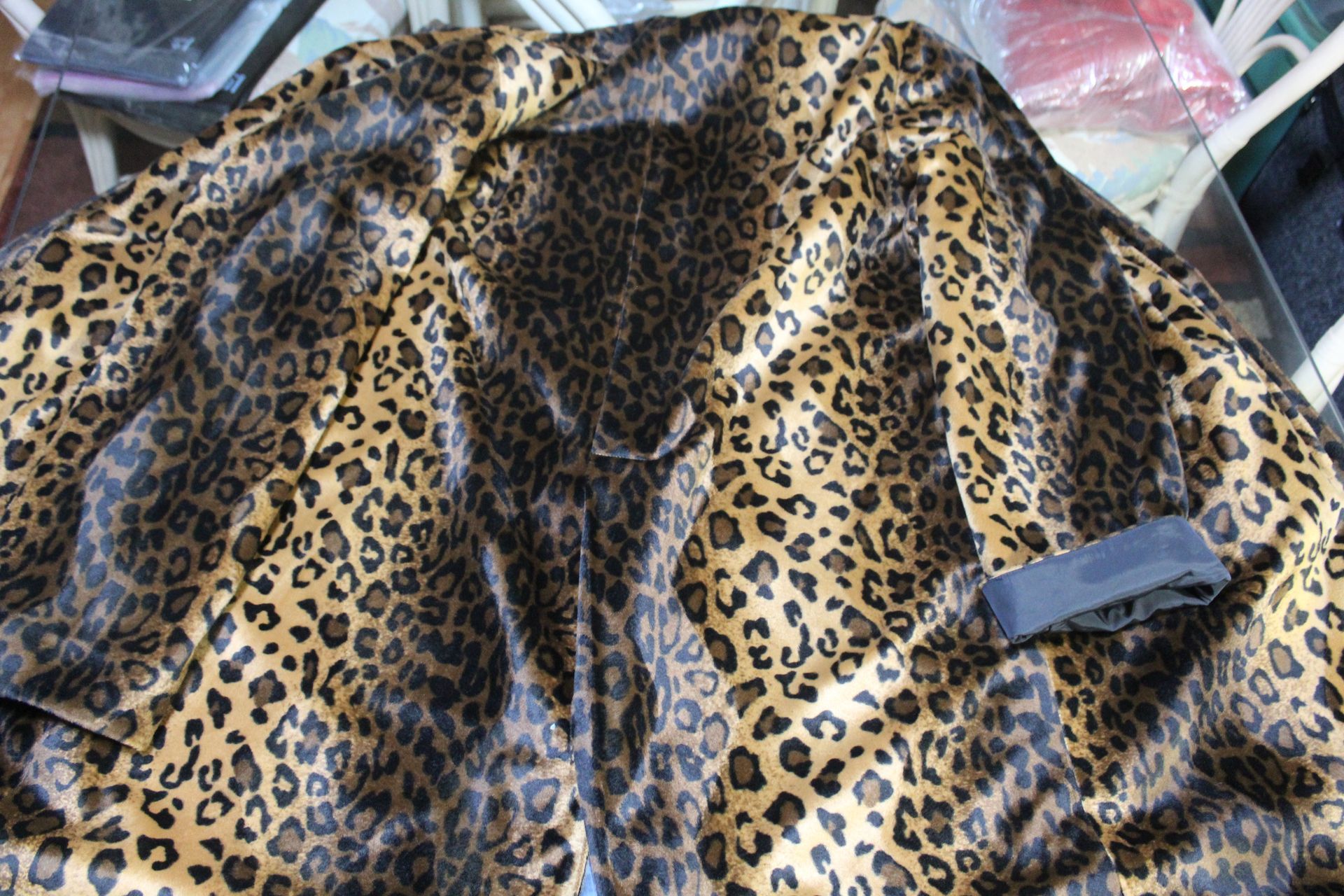 Leopard-print faux fur garment laid out on plastic packaging