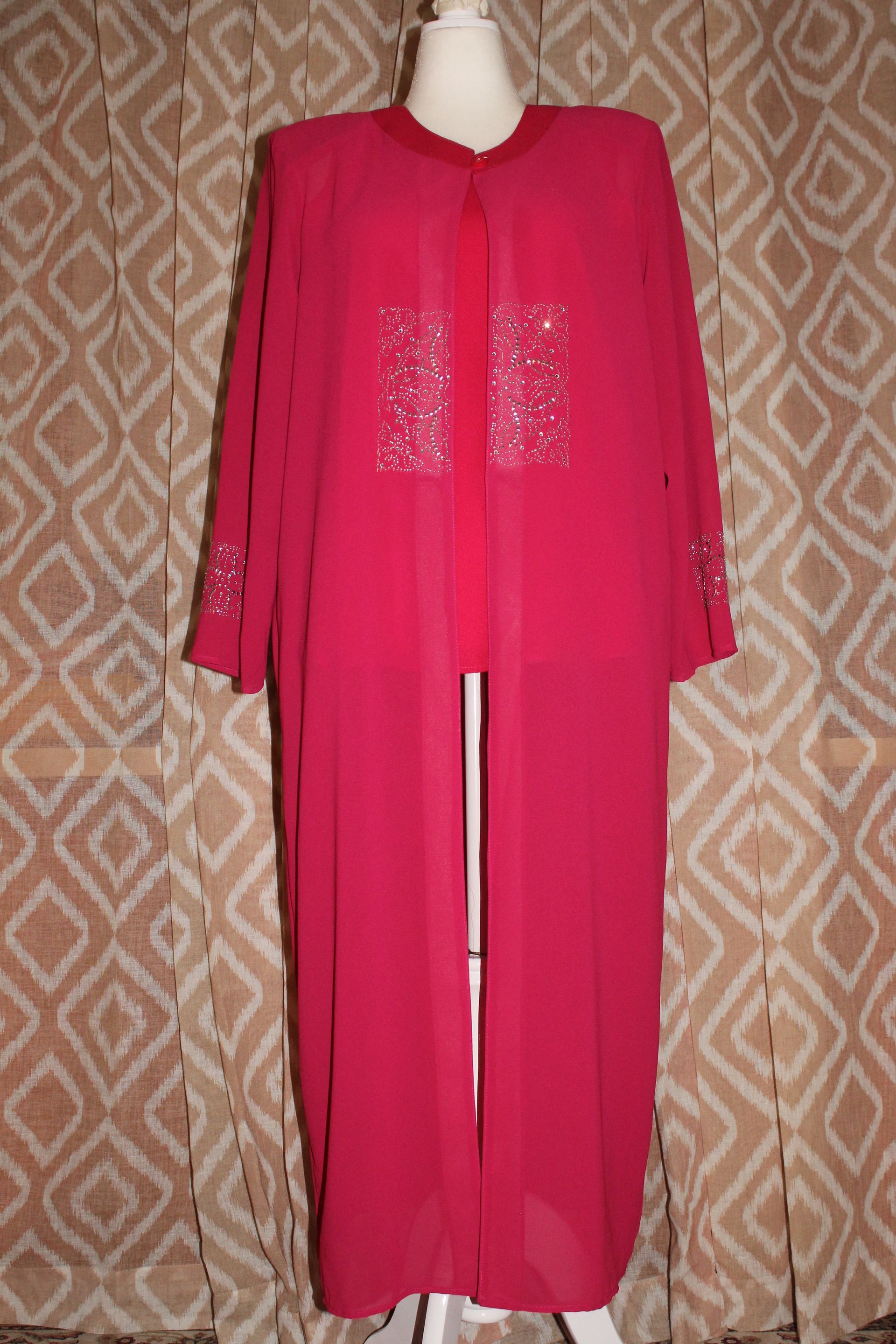 Pink long-sleeve maxi dress displayed on a mannequin against a patterned backdrop