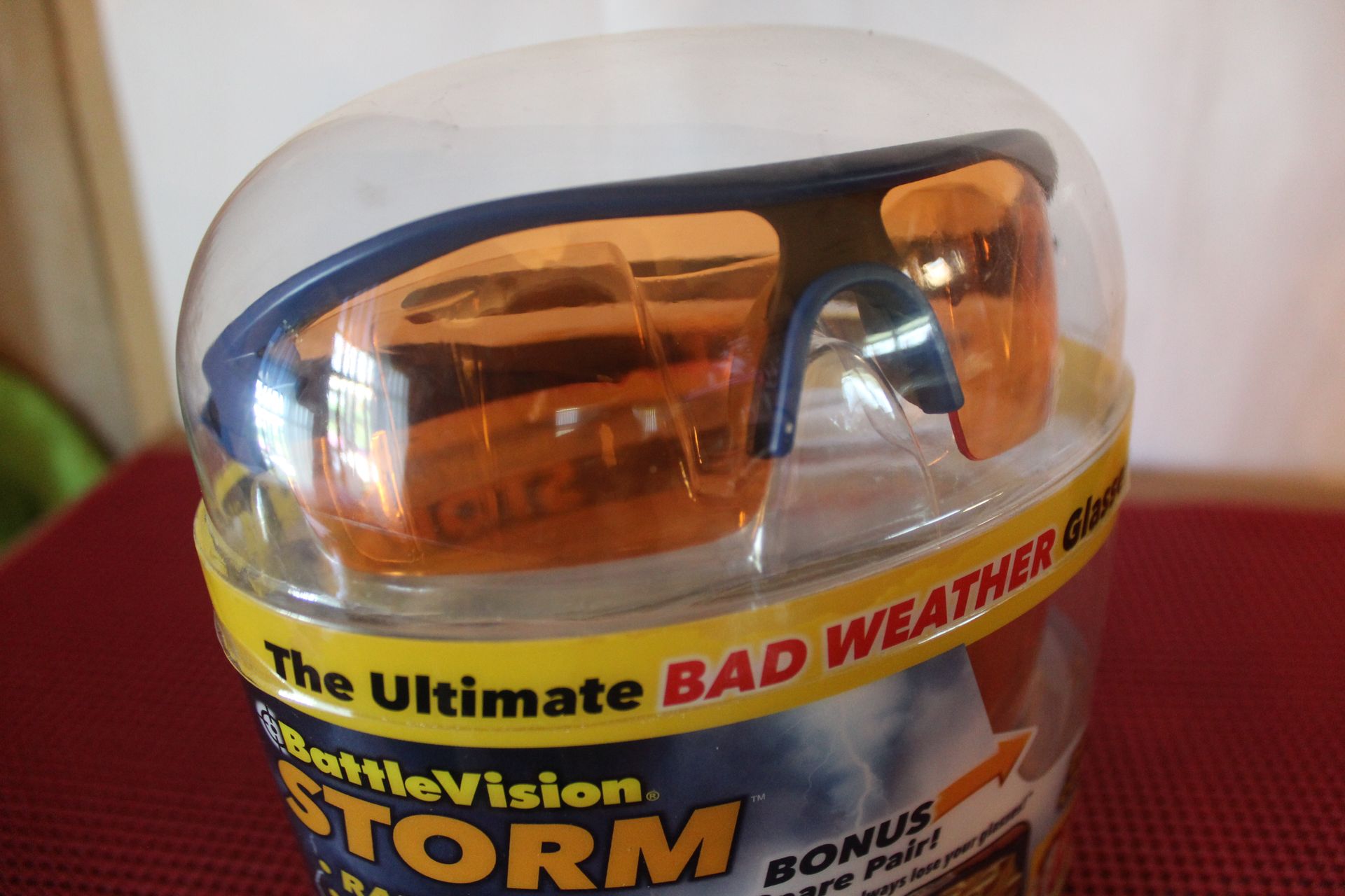 Amber strobe light in a clear dome on a product package labeled “The Ultimate BAD WEATHER”