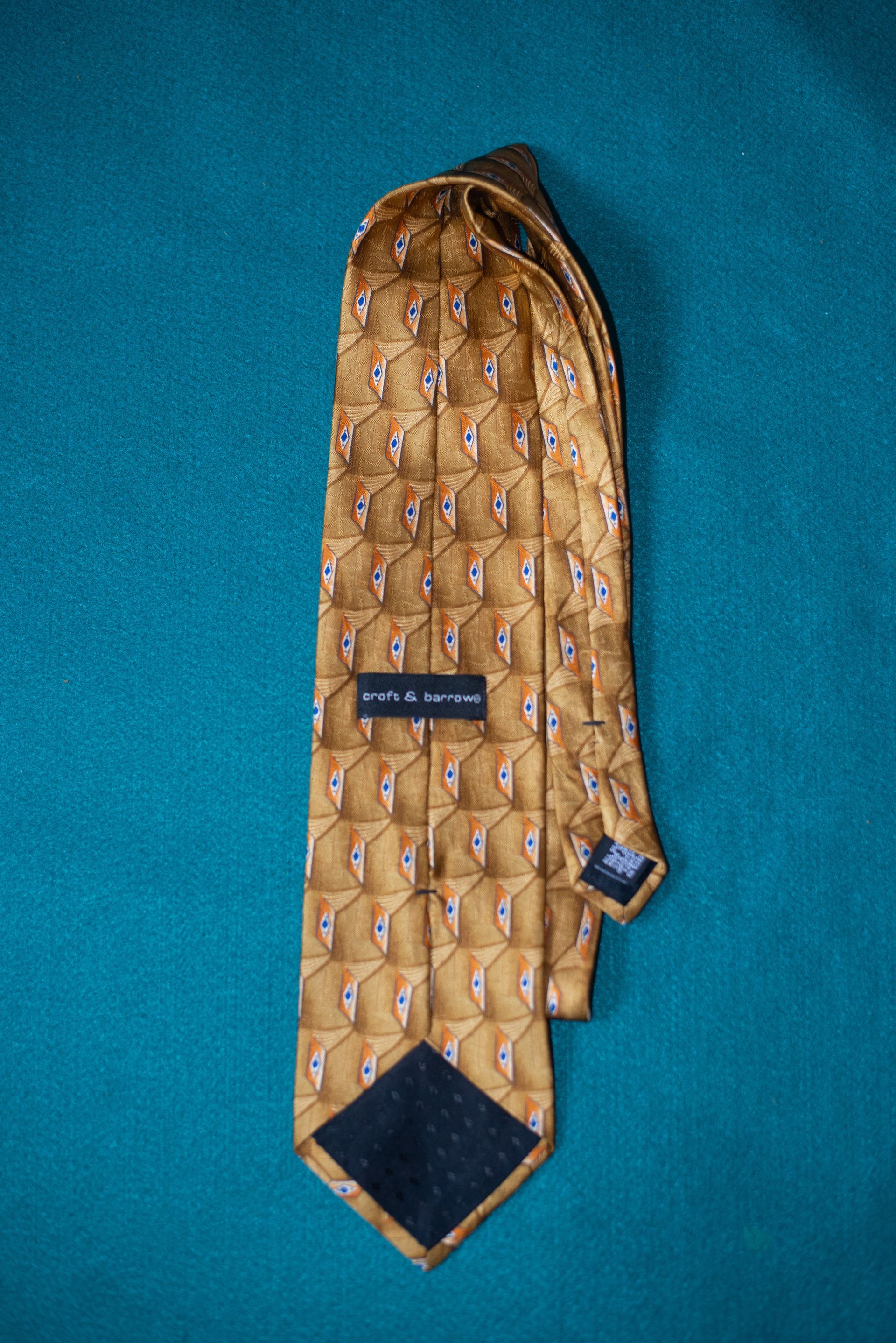 Brown patterned necktie on a blue background.