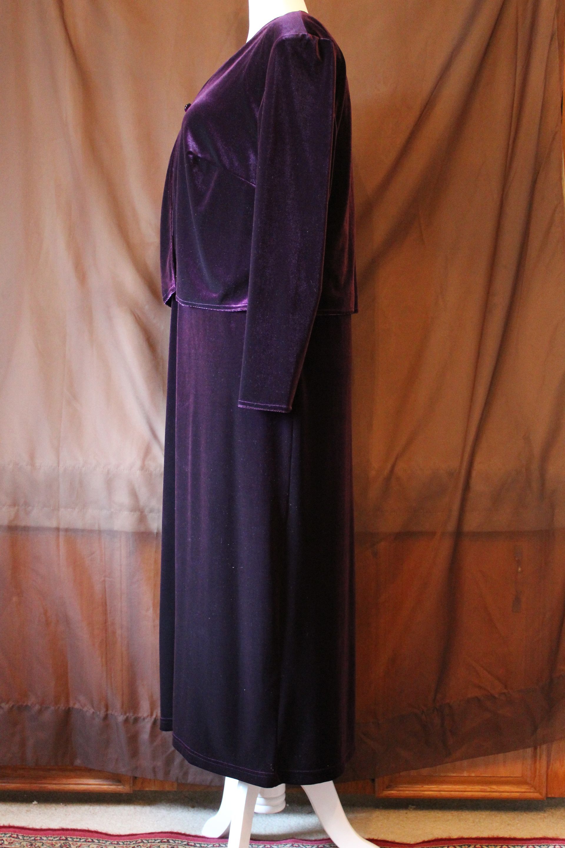 Purple long-sleeve dress on a mannequin against a brown backdrop