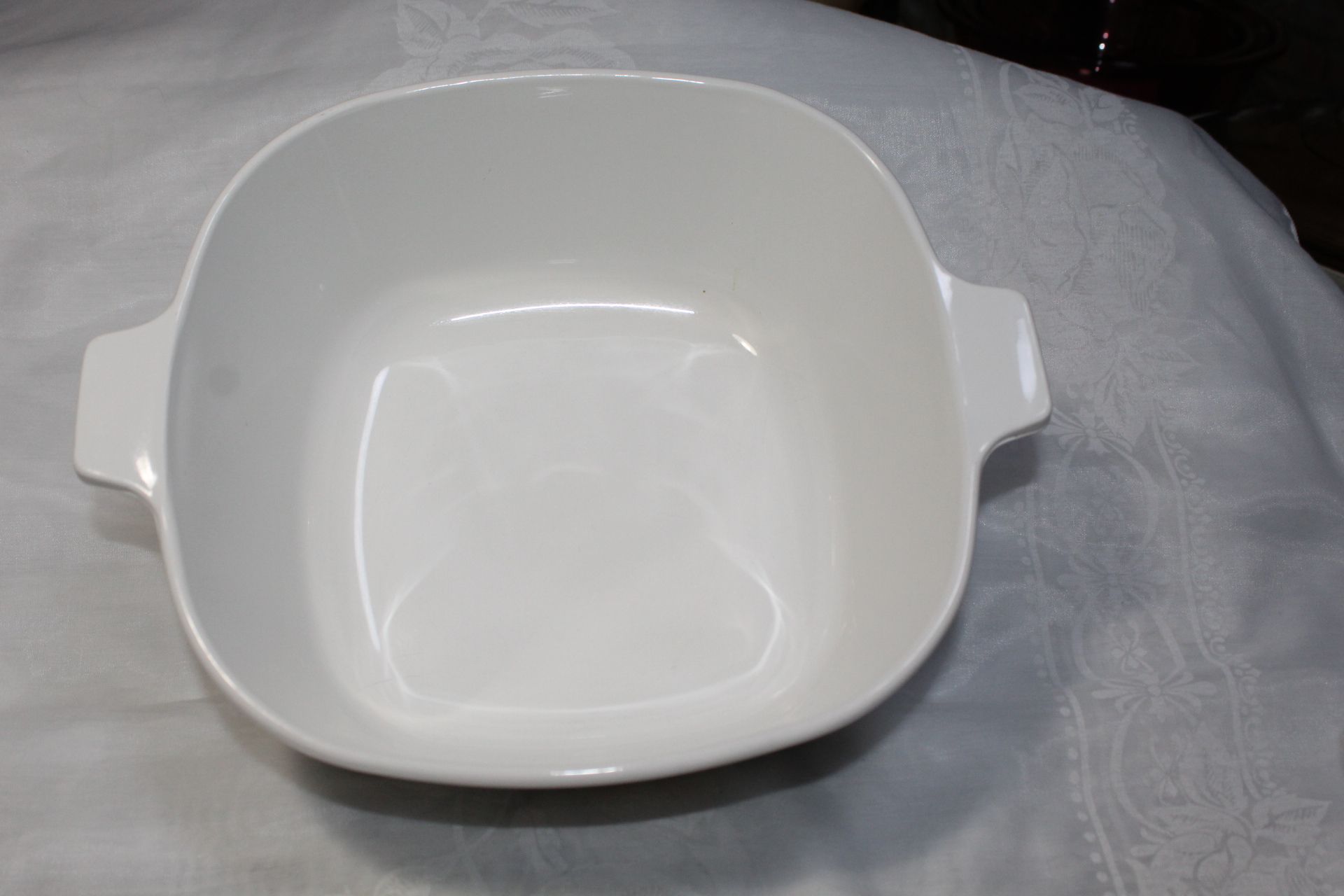 White ceramic bowl with blue floral pattern on the side