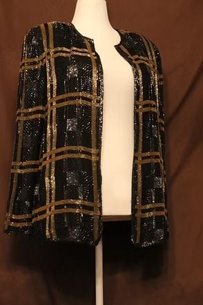 Black and gold plaid jacket on a mannequin against a brown backdrop