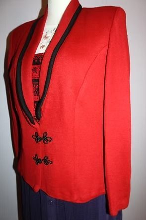 Red blazer with black trim and decorative clasps on a mannequin
