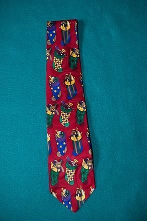 Red tie with colorful owl pattern on a teal background