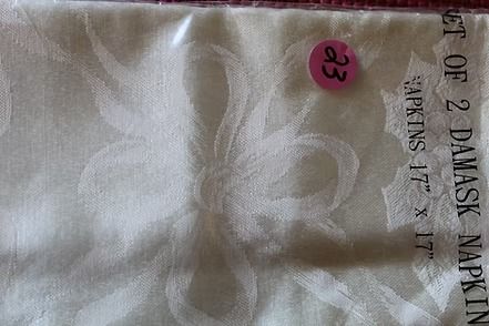 Close-up of white patterned fabric with black text and a pink “93” sticker on the right edge
