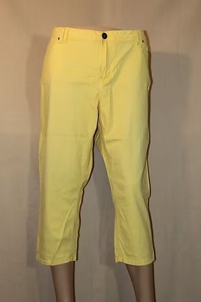 Yellow capri pants on a mannequin against a plain beige background.