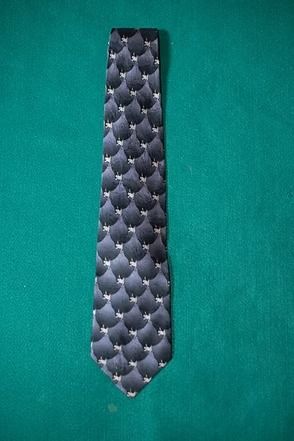 Black patterned necktie on a teal background